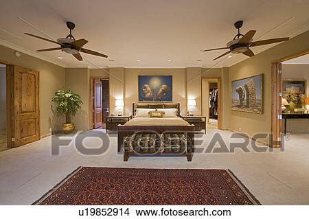 Picture - Bedroom interior with ceiling fans. Fotosearch
