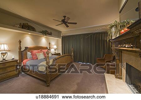 Stock Image - Bedroom interior with fireplace. Fotosearch