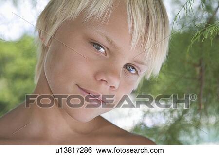 Stock Photograph - Blonde boy aged 12-13 years. Fotosearch