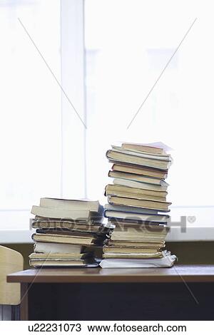 Books stacked on library table View Large Photo Image Stock Image - Books stacked on library table. Fotosearch