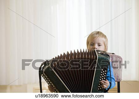 Boy (3-4) playing accordion View Large Photo Image Stock Image - Boy (3-4) playing accordion. Fotosearch