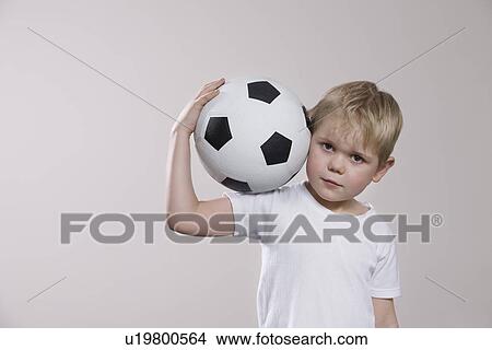 Picture - Boy holding soccer ball portrait. Fotosearch