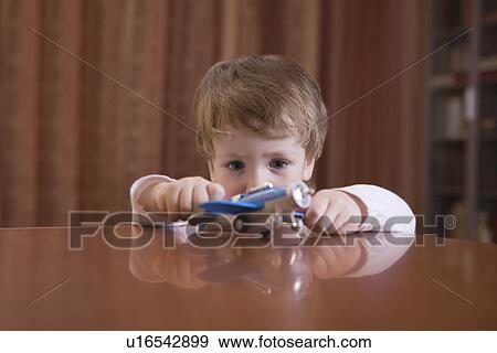 Boy playing with toy airplane View Large Photo Image Stock Photo - Boy playing with toy airplane. Fotosearch
