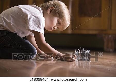 Boy playing with toy soldiers on floor View Large Photo Image Picture - Boy playing with toy soldiers on floor. Fotosearch