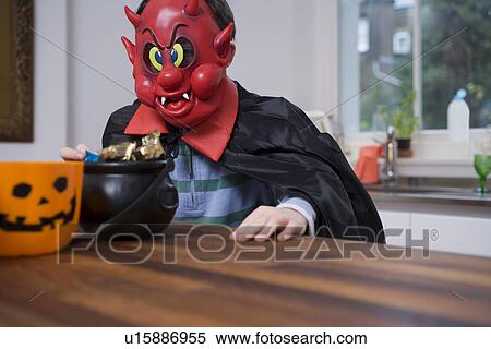 Boy wearing scary costume in kitchen View Large Photo Image Stock Photography - Boy wearing scary costume in kitchen. Fotosearch