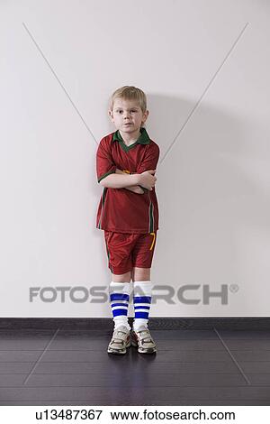 Boy wearing sports clothing leaning ageist wall View Large Photo Image Stock Photo - Boy wearing sports clothing leaning ageist wall. Fotosearch