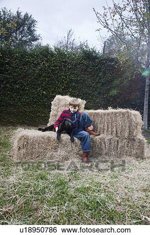 Boy with dog on hay bale View Large Photo Image Stock Photograph - Boy with dog on hay bale. Fotosearch
