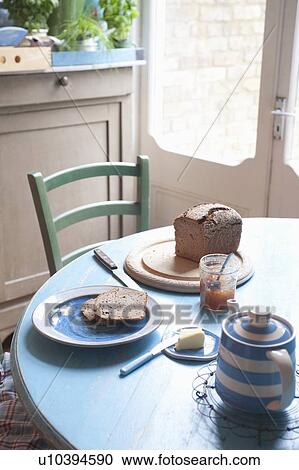 Stock Image - Bread and butter on kitchen table near back door. Fotosearch