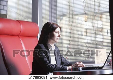 Business woman using laptop in cafe View Large Photo Image Stock Image - Business woman using laptop in cafe. Fotosearch