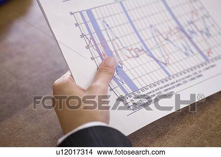 Businessman holds report View Large Photo Image Picture - Businessman holds report. Fotosearch