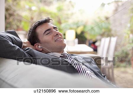 Stock Photograph - Businessman relaxing at home. Fotosearch