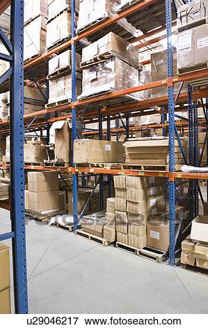 Cardboard boxes on shelves in distribution warehouse View Large Photo Image Stock Photo - Cardboard boxes on shelves in distribution warehouse. Fotosearch
