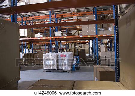Cardboard boxes on shelves in distribution warehouse View Large Photo Image Stock Photograph - Cardboard boxes on shelves in distribution warehouse. Fotosearch