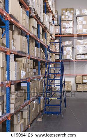 Stock Photography - Cardboard boxes on shelves in distribution warehouse. Fotosearch