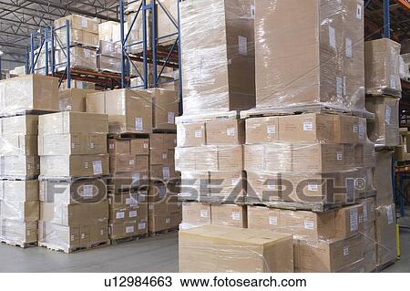 Cardboard boxes stacked in distribution warehouse View Large Photo Image Stock Image - Cardboard boxes stacked in distribution warehouse. Fotosearch