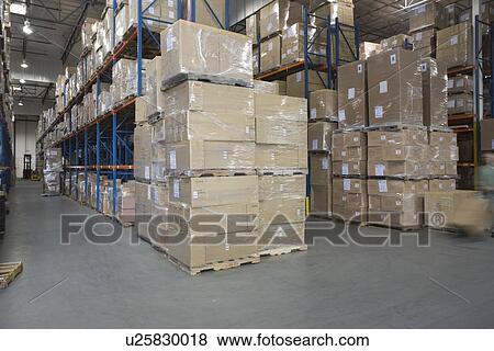 Cardboard boxes stacked in distribution warehouse View Large Photo Image Stock Photo - Cardboard boxes stacked in distribution warehouse. Fotosearch