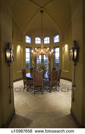 Chandelier hangs over table in Palm Springs dining room View Large Photo Image Stock Photo - Chandelier hangs over table in Palm Springs dining room. Fotosearch