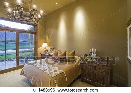Stock Photograph - Chandelier in bedroom of Palm Springs home. Fotosearch