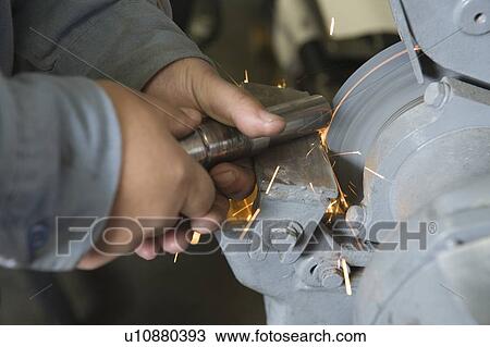 Stock Image - Close up of man in workshop with tools. Fotosearch