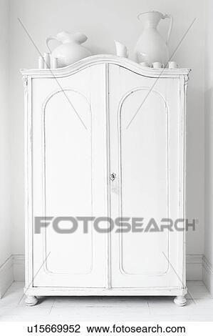 Stock Image - Closed storage cupboard painted white. Fotosearch
