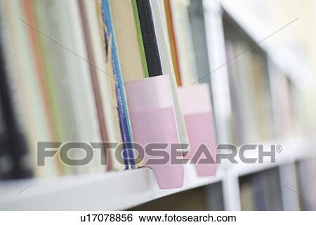 Stock Photograph - Colour coded filing system on library shelves. Fotosearch