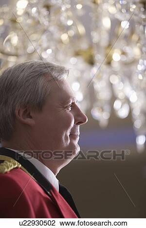 Stock Image - Concierge smiling side view portrait. Fotosearch