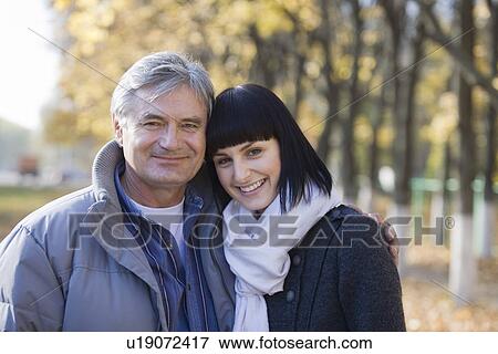 Stock Photo - Couple embracing in park portrait. Fotosearch