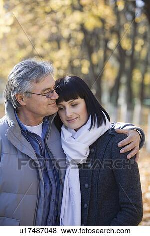 Stock Photo - Couple embracing in park. Fotosearch