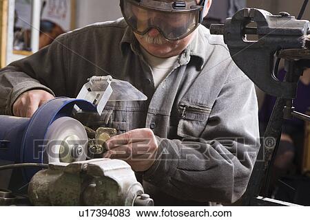 Stock Image - Craftsman working with stone close-up. Fotosearch