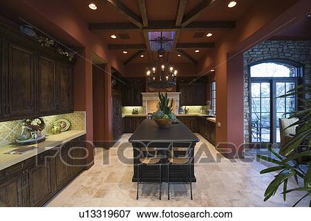 Stock Photo - Dark wood and beamed ceilings of Palm Springs kitchen interior. Fotosearch