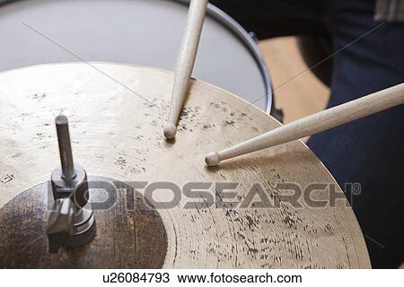 Drumsticks on metal cymbal View Large Photo Image Stock Image - Drumsticks on metal cymbal. Fotosearch