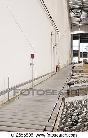 Stock Photograph - Empty conveyor belt in distribution warehouse. Fotosearch