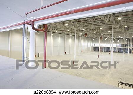 Empty warehouse with red piping View Large Photo Image Picture - Empty warehouse with red piping. Fotosearch