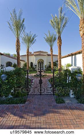 Stock Photography - Entrance gate to luxurious house in colonial style. Fotosearch