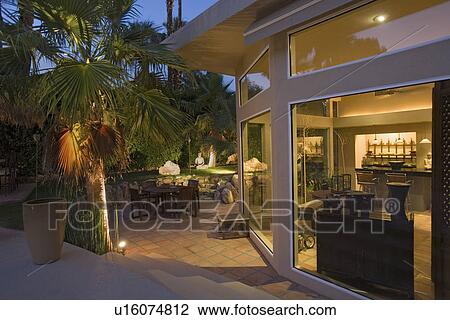 Stock Image - Exterior of modern home dusk. Fotosearch