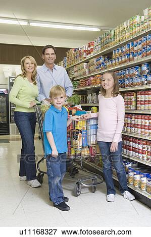 Stock Photo - Family of four shopping in supermarket. Fotosearch