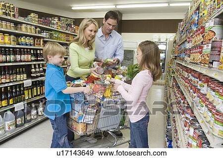 Stock Photo - Family of four shopping in supermarket. Fotosearch