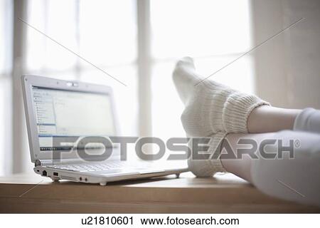 Feet up in loft apartment with laptop View Large Photo Image Stock Image - Feet up in loft apartment with laptop. Fotosearch