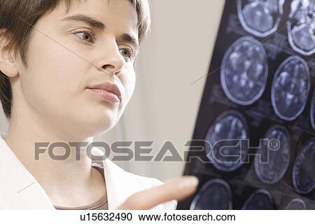 Female doctor analyzing CAT scan View Large Photo Image Stock Image - Female doctor analyzing CAT scan. Fotosearch