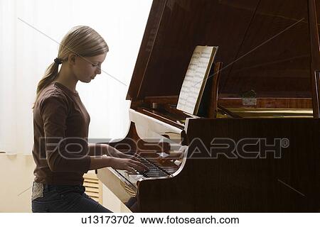 Girl (13-15) playing piano View Large Photo Image Stock Image - Girl (13-15) playing piano. Fotosearch