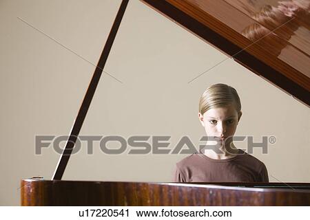 Girl (13-15) playing piano View Large Photo Image Stock Image - Girl (13-15) playing piano. Fotosearch