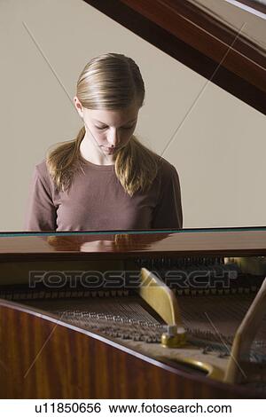 Girl (13-15) playing piano View Large Photo Image Stock Photograph - Girl (13-15) playing piano. Fotosearch