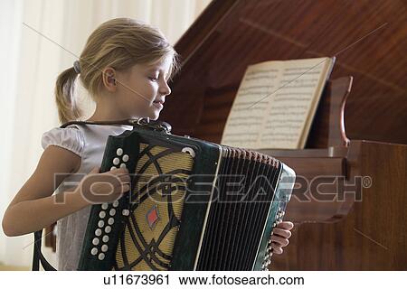 Girl (5-6) playing accordion View Large Photo Image Stock Image - Girl (5-6) playing accordion. Fotosearch