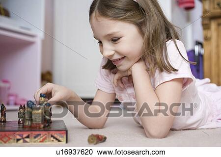 Girl playing board game on floor View Large Photo Image Stock Image - Girl playing board game on floor. Fotosearch