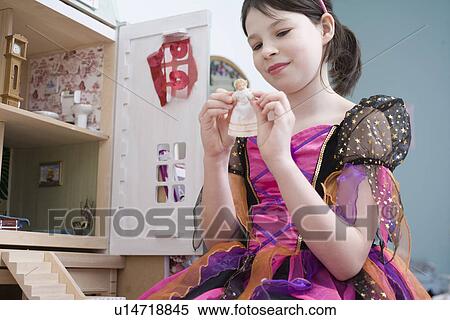 Girl playing with doll house View Large Photo Image Stock Photography - Girl playing with doll house. Fotosearch