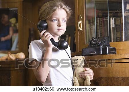 Girl using telephone at home View Large Photo Image Stock Image - Girl using telephone at home. Fotosearch