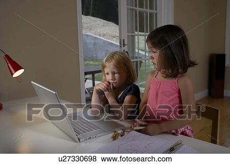 Girls using computer View Large Photo Image Stock Photo - Girls using computer. Fotosearch