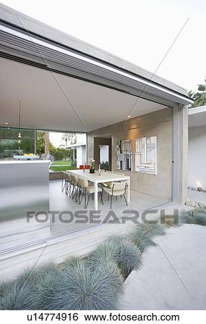 Glass wall of open plan dining / kitchen area in Palm Springs home View Large Photo Image Stock Photograph - Glass wall of open plan dining / kitchen area in Palm Springs home. Fotosearch