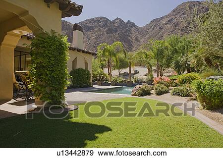 Stock Photo - House exterior with swimming pool in garden. Fotosearch