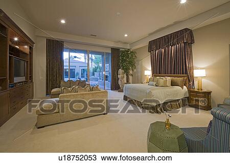 Illuminated bedroom in luxurious residence View Large Photo Image Stock Image - Illuminated bedroom in luxurious residence. Fotosearch